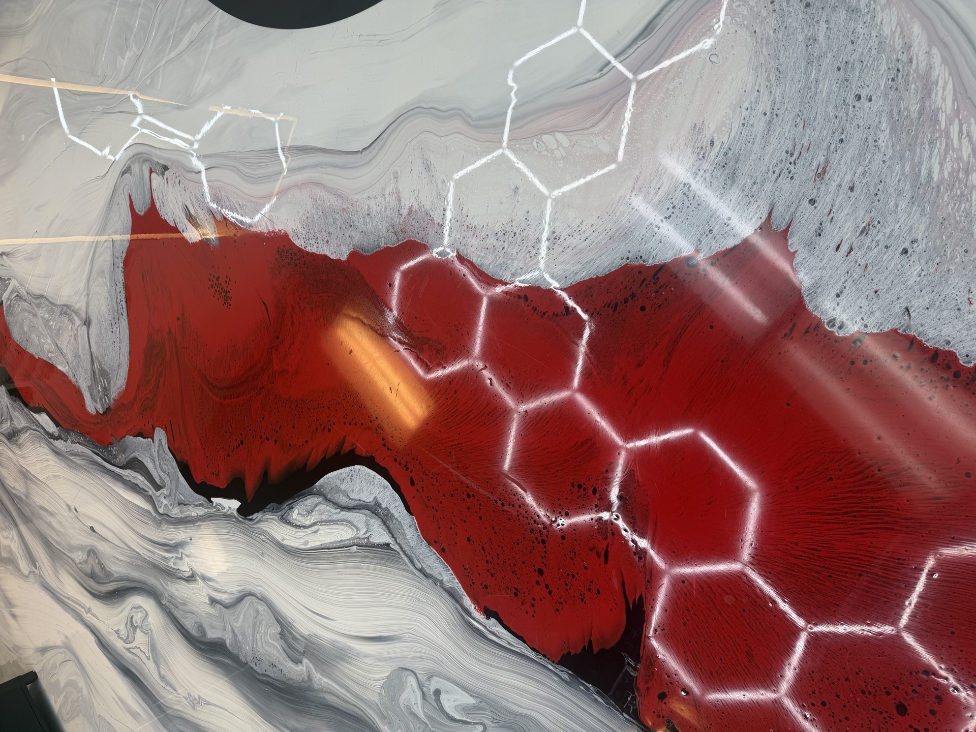 Catrines Barbershop marble epoxy floor with red veins and hexagon LED reflections